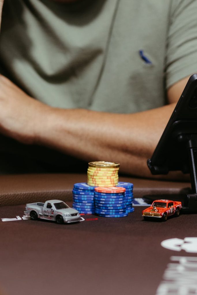 An intriguing close-up of poker chips and toy cars on a poker table, capturing the casino atmosphere.