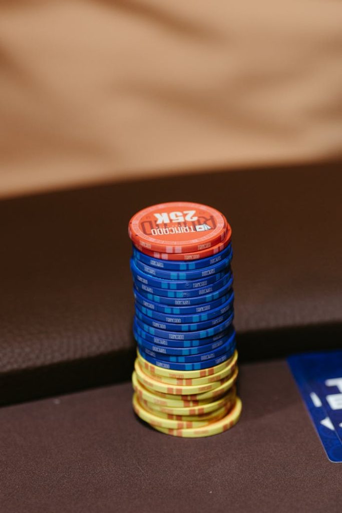 Colorful poker chips stacked on a casino table, ready for a game.